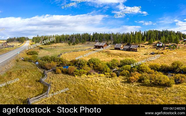 Abandoned and decayed old wooden barn, farm facilities and buildings in Towdystan in western Chilcotin District of the Central Interior of British Columbia