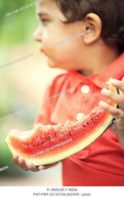 Baby boy holding a watermelon
