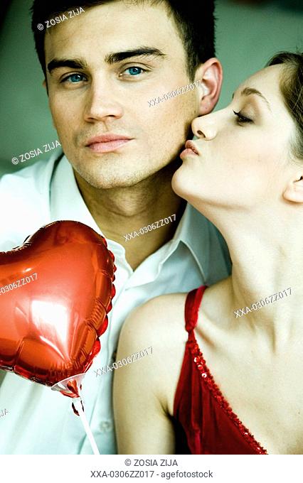 woman kissing man's cheek