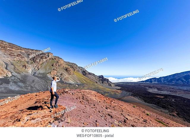 Tourist enjoying view from Sliding Sands Trail, Haleakala volcano, Haleakala National Park, Maui, Hawaii, USA