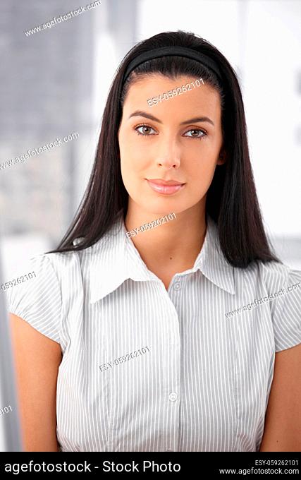 Portrait of attractive woman with dark hair smiling at camera