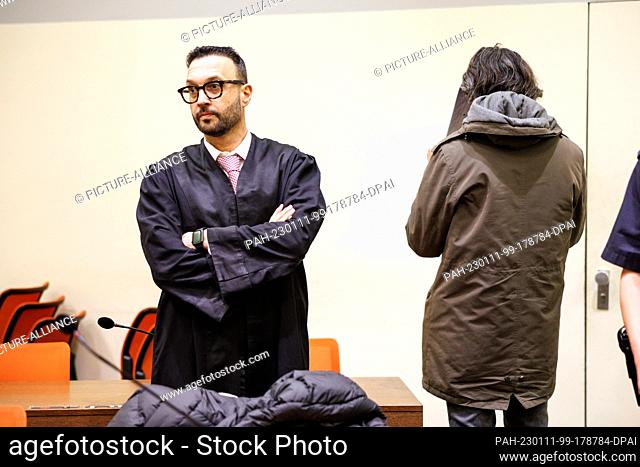 11 January 2023, Bavaria, Munich: A man accused of killing his benefactress out of greed (r) stands next to his lawyer Adam Ahmed before the start of the trial...