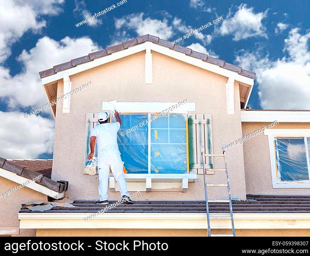 Professional House Painter Painting the Trim And Shutters of A Home