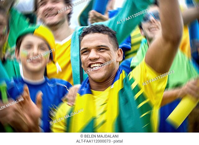 Brazilian football fans cheering at football match