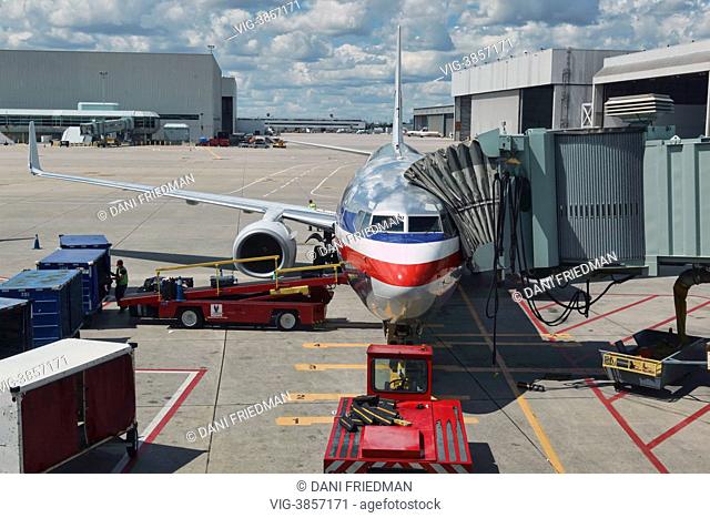 CANADA, MISSISSAUGA, Workers load luggage onto an American Airlines airplane just before takeoff at Lester B. Pearson International Airport in Ontario, Canada