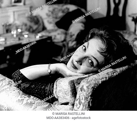 Portrait of Andreina Pagnani at home. Portrait of Italian actress Andreina Pagnani (Andreina Gentili) sitting in a chair, in her house. Rome, 1964