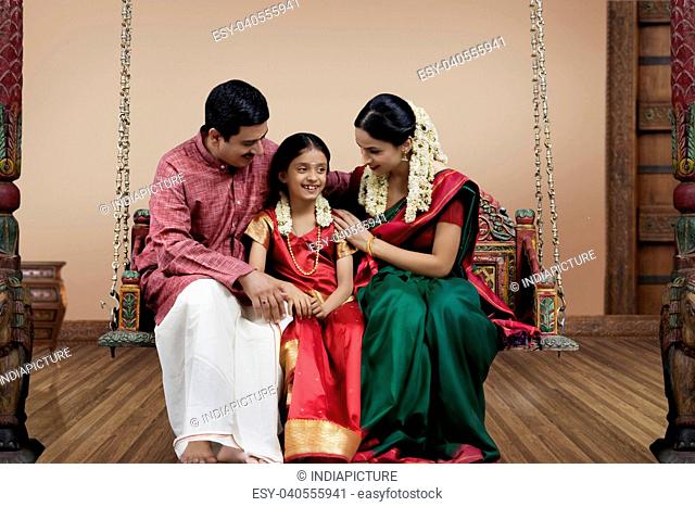 South Indian family sitting on a jhula