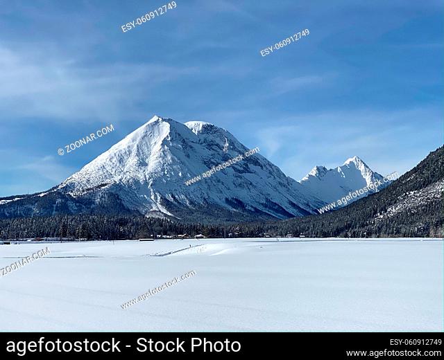 Winter mountains landscape with groomed ski track and dramatic sky, Leutasch, Austria. The village of Leutasch is a byword for cross-country skiing