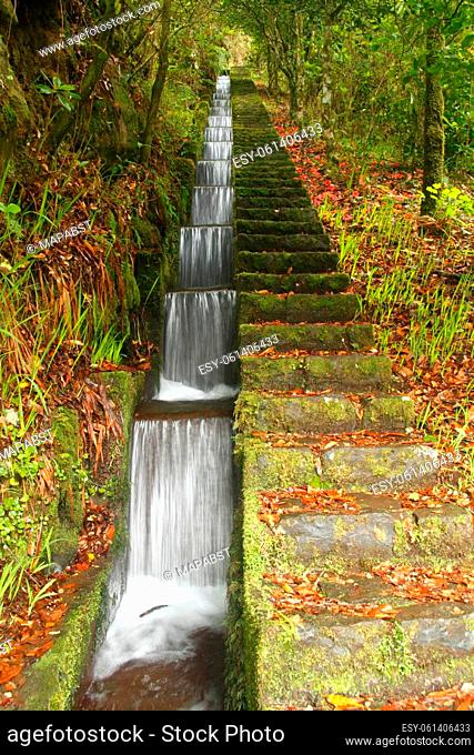 Artificial cascade of the Levada do furado in Ribeiro Frio on Madeira island Portugal. Longtime exposure of historic active water supply system with geometrical...