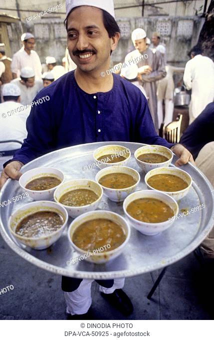 man serving food , ID celebration , india
