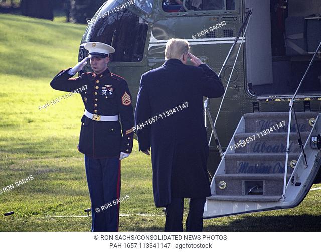United States President Donald J. Trump salutes the Marine Guard as he boards Marine One on the South Lawn of the White House in Washington