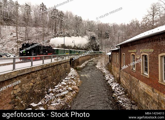Rabenau, snow in valley 'Rabenauer Grund', river 'Rote Weißeritz', narrow gauge steam train of Weißeritztalbahn (Weisseritz Valley Railway) at station Rabenau