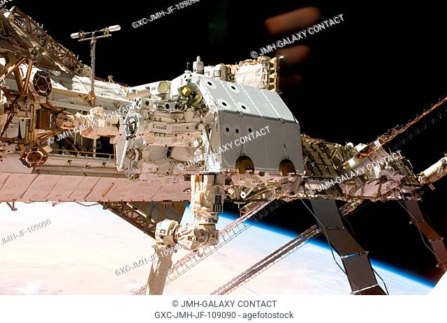 In the grasp of the International Space Station's (ISS) robotic Canadarm2, the Canadian-built Dextre robotic system is moved to its place on a station truss...
