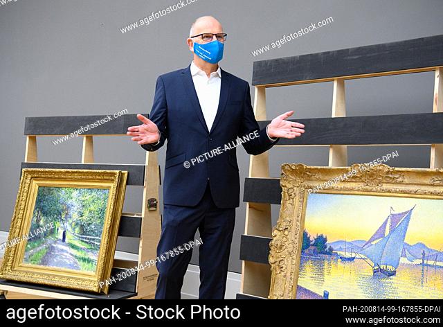 14 August 2020, Brandenburg, Potsdam: Dietmar Woidke (SPD), Prime Minister of Brandenburg, stands during his press tour with blue mouth-nose protection in the...