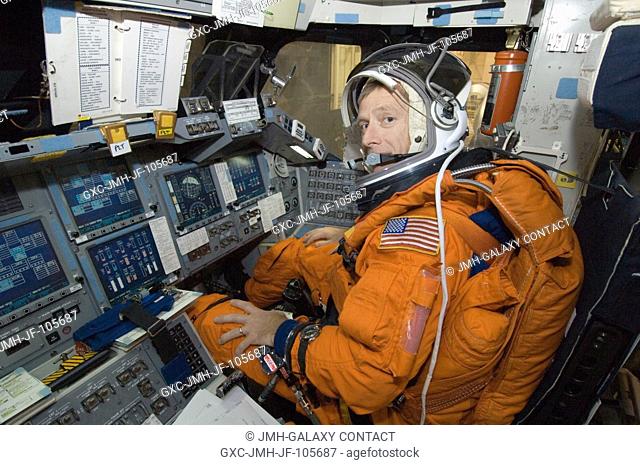 Astronaut Christopher J. Ferguson, STS-115 pilot, attired in a training version of the shuttle launch and entry suit, occupies the pilot's station in one of the...