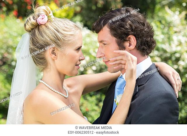 Groom looking at his pretty blonde wife