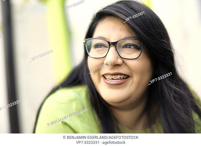 smiling woman wearing glasses and braces