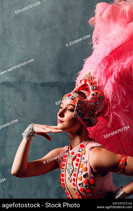 Woman in samba or lambada costume with pink feathers plumage