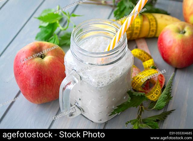 Organic smoothie of nettle, apple and banana in jar. Healthy lifestyle concept. Tape mesure