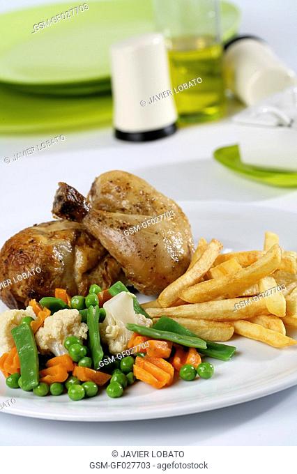 Mixed main course with half roast chicken, French fries and vegetables