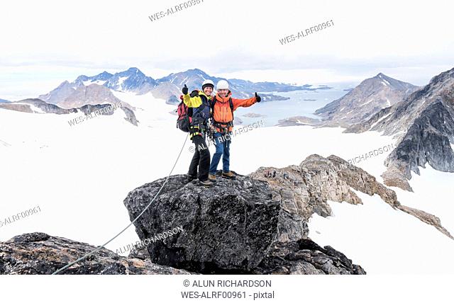 Greenland, Sermersooq, Kulusuk, Schweizerland Alps, portrait of happy mountaineers on summit