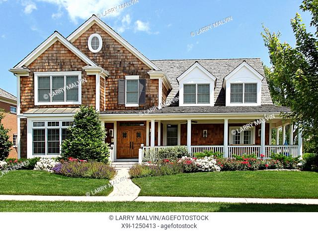 Suburban home with flowered landscaping and front porch