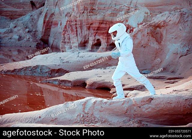 futuristic astronaut on another planet, sandy red planet