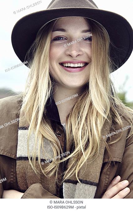 Portrait of blond haired young woman in outdoor clothes
