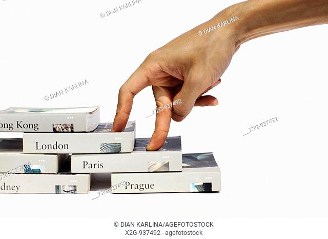 A male hand on a stack of books