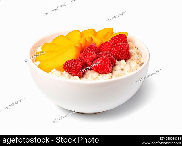 prepared oatmeal with fruits and berries isolated on white background