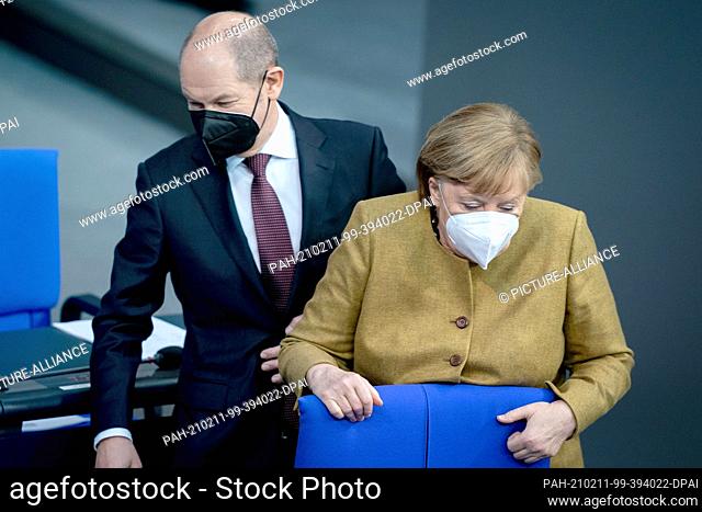 11 February 2021, Berlin: Olaf Scholz (SPD), Federal Minister of Finance, and Chancellor Angela Merkel (CDU) attend the plenary session of the German Bundestag