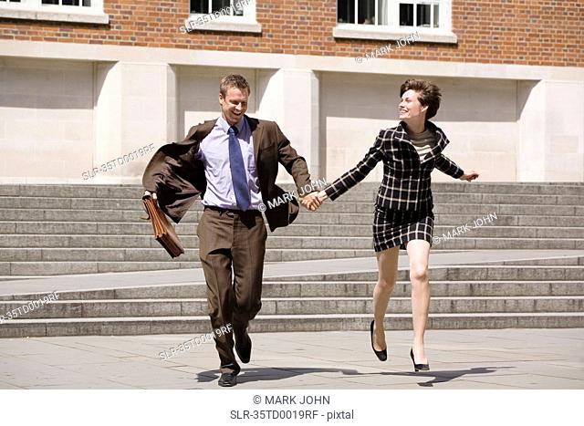 Business people holding hands outdoors