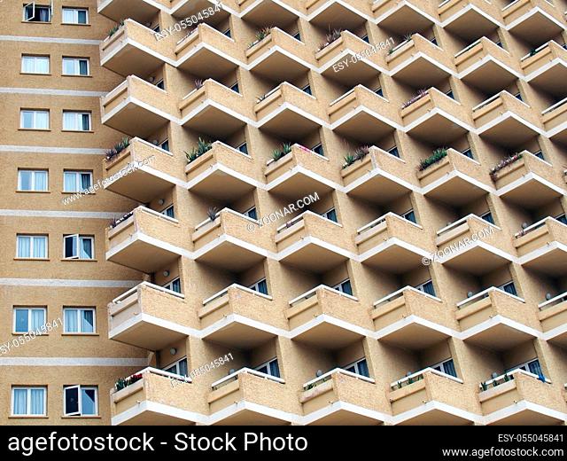 large residential highrise building with angular rows of balconies and vertical lines of windows