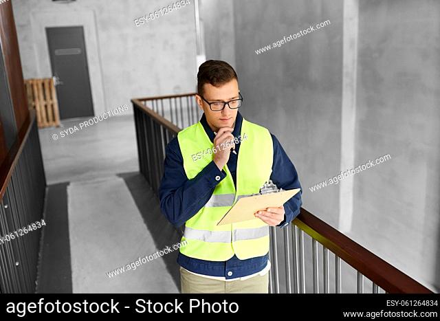 male worker with clipboard at office