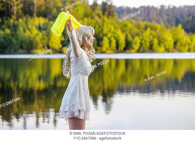 Calm lake and teen girl with Yellow scarf overhead