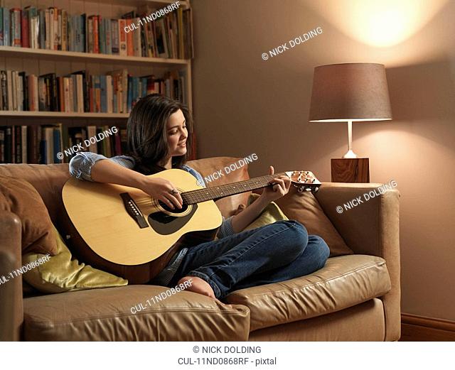 Girl, 14 playing guitar