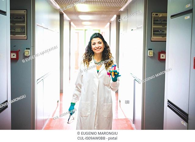 Female scientist walking in laboratory of material science and nanotechnology