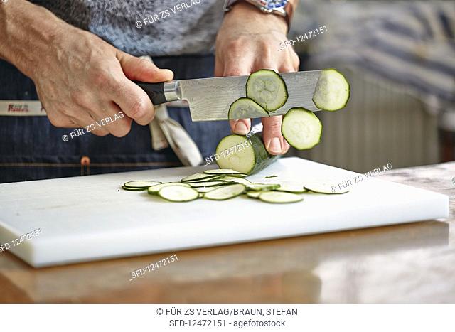 Courgette being finely sliced