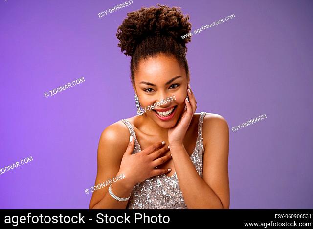 Close-up flirty cheeky young stylish african american woman attend luxurious party in silver dress giggling receive compliment smiling gladly touch chest...
