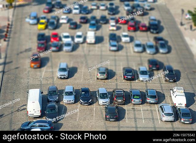 Big parking with lot of different cars seen from above with tilt shift effect
