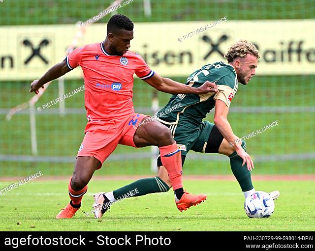 28 July 2023, Austria, Lienz: Soccer: Test match, Udinese Calcio - 1. FC Union Berlin, Christian Kabasele (l) of Udinese Calcio and Union's Benedict Hollerbach...