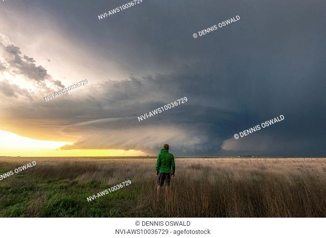Storm chaser and photographer self portrait with a supercell over the fields of Leoti, Wichita County, Kansas, USA on May 21st 2016