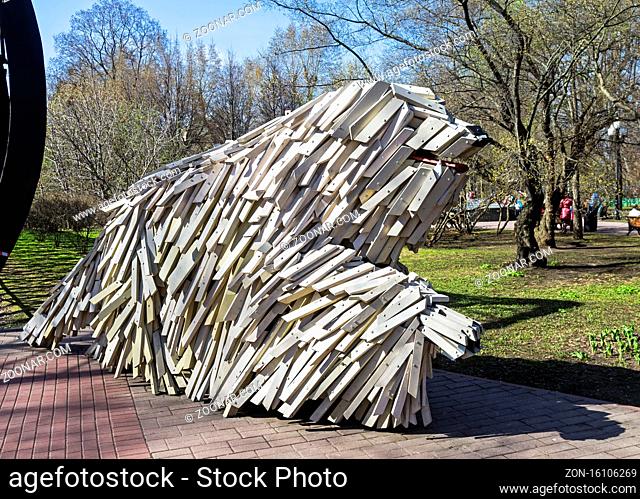 MOSCOW, RUSSIA, APRIL 29, 2017: A funny sculpture of a large white furry dog. The entrance to Pushkin's pedestrian bridge. Moscow, Russia