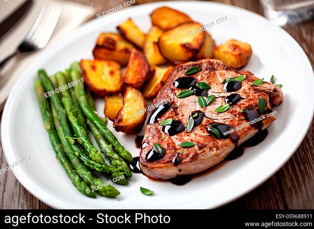 Fillet of beef with potatoes and asparagus on a plate
