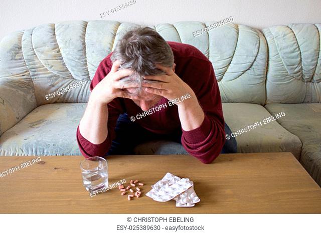 risk of suicide of a man, pills on the table