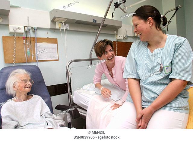 ELDERLY HOSP. PATIENT WITH NURSE<BR>Photo essay from hospital.<BR>Geriatrics unit. A 95-year-old patient receives a family visit
