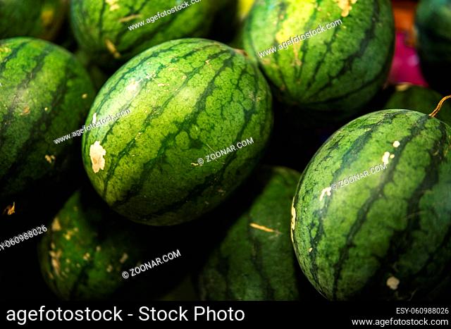Ripe and sweet watermelons in the market. Close up. A lot of large ripe green striped watermelons. Organic farmer market, store