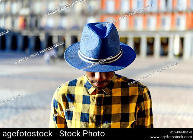 African man wearing hat while standing in city
