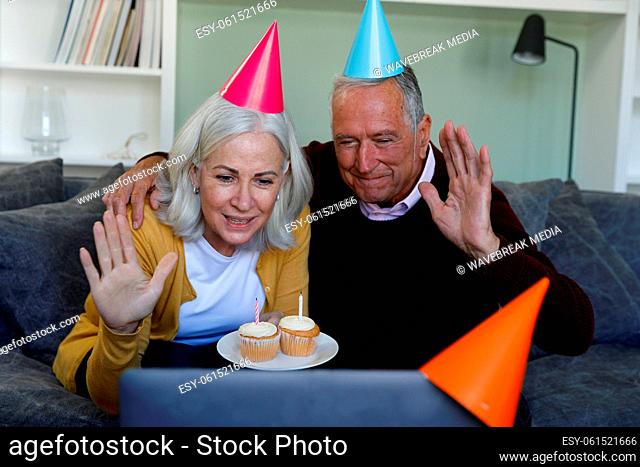 Senior caucasian couple celebrating birthday while having a video chat on laptop at home