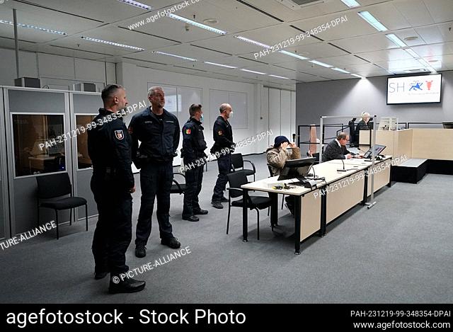 19 December 2023, Schleswig-Holstein, Itzehoe: Defendant Ibrahim A. (5th from left) sits in the courtroom at the China Logistic Center